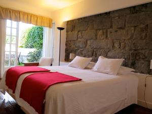 Säng eller sängar i ett rum på Quinta das Buganvílias