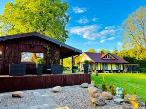 a house with a yard with a garden sidx sidx sidx at AGUONA ROYAL OASIS in Molėtai