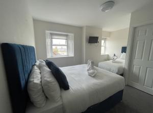 a bedroom with two beds and a couch and a window at The Norton- Hartlepool in Seaton Carew