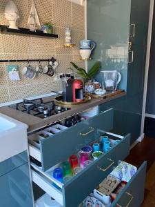 an open drawer in a kitchen with a stove at B&B il Duca d'Amalfi in Salerno