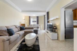 een woonkamer met een bank en een tv bij AZUL by the Sea in Villamartin