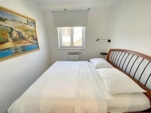 1 dormitorio con 2 camas y un cuadro en la pared en One bedroom apartement at Novigrad 400 m away from the beach with enclosed garden and wifi, en Novigrad Istria