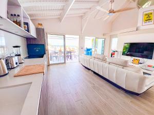a living room with a couch and a table at Villa Marguerite private pool and hot tub in Orient Bay in Orient Bay