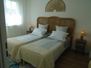 two beds sitting next to each other in a bedroom at Bagatelle in Courseulles-sur-Mer