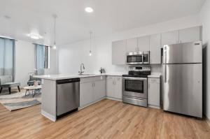 a kitchen with white cabinets and stainless steel appliances at Town St Medical Lofts in Columbus