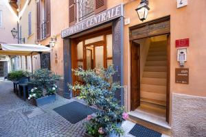 a building with a sign for a restaurant on a street at Locanda del Centrale in Cremona
