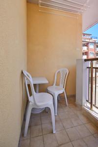 a table and two chairs on a balcony at Студио Калина in Pomorie