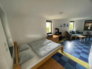 a bedroom with a bed and a living room at Ubytování Okružní 396 in Sezimovo Ústí