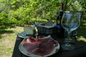 a table with a plate of meat and a wine glass at Casino del Monaco in Casalvieri