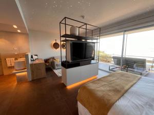 a bedroom with a bed and a television in a room at Canyelles Platja in Roses