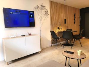 a living room with a large tv on a wall at Apartament z sauną Polanica-Zdrój in Polanica-Zdrój