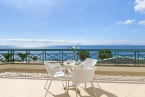 a table and chairs on a balcony overlooking the ocean at Hipotels Natura Palace Adults Only in Playa Blanca