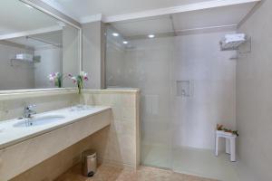 a bathroom with a sink and a shower at Hipotels Natura Palace Adults Only in Playa Blanca
