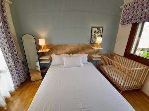 a large white bed in a room with a window at Theros Aegean Villa in Iraklitsa