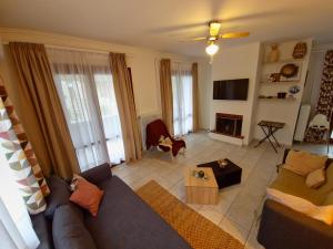 a living room with a couch and a table at Theros Aegean Villa in Iraklitsa