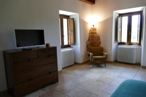 1 dormitorio con vestidor, TV y silla en Casino del Monaco, en Casalvieri