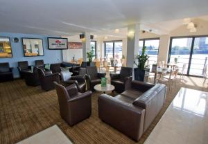 a lobby with couches and chairs and a table and tables at The Dolby Hotel Liverpool - Free city centre parking in Liverpool