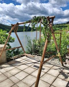 a wooden arbor with a view of a body of water at Hotel Plumlov in Mostkovice