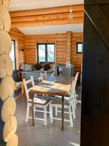 a dining room with a table and chairs in a cabin at Private Mountain Log Cabin with amazing panoramic sunset views at small scale nature resort in Cabeceiras de Basto