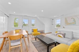 a living room with a table and a couch at 19 State Street Sandwich - Marsh Mellow in Sandwich