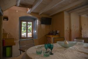 a dining room with a table with glasses on it at Stonehome Pojata in Rušići