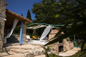 a patio with a tent and a chair at Stonehome Pojata in Rušići
