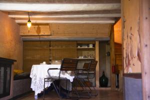 a dining room with a table and two chairs at Stonehome Pojata in Rušići
