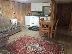 a living room with a table and a kitchen at Guesthouse Dolunay in Ayder Yaylasi