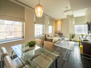 a living room with a glass table and a couch at The Marmara Park Avenue in New York