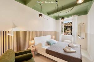 a bedroom with a bed and a couch and a window at Il Mare Sotto in Riomaggiore