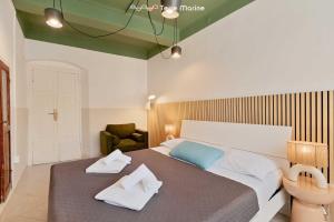 a bedroom with a large bed with two pillows on it at Il Mare Sotto in Riomaggiore