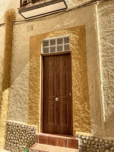 a wooden door on the side of a building at 2 bedrooms apartement with balcony and wifi at Albunol 7 km away from the beach in Albuñol