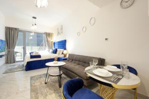a living room with a couch and a bed at Silk Valley - Furnished Studio With Balcony in Abu Dhabi