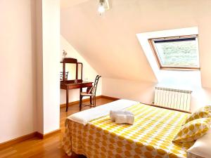 a bedroom with a bed and a desk in a attic at Alianza del Castillo in Ponferrada +7 photos