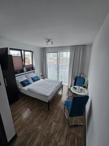 een slaapkamer met een bed en een tafel en stoelen bij Sunset Beach in Sarbinowo