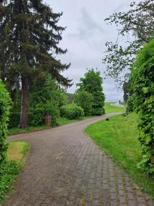 a cobblestone road in a park with trees and grass at Ferienwohnung Anna in Schramberg