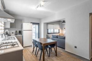 a kitchen and living room with a table and a couch at NewOld Flat in Bodrum City
