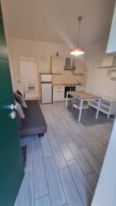 a living room and kitchen with a table and a couch at Borgolombardo Policlinico Eni San Giuliano M in San Giuliano Milanese