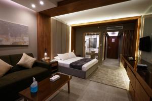 een hotelkamer met een bed en een bank bij Ali Baba Palace -Families and Couples Only- in Hurghada
