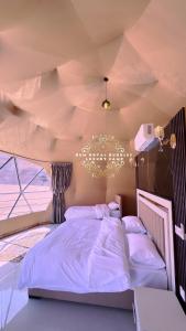 a bedroom with a large bed in a room at RUM ROYAL BUBBLES lUXURY CAMP in Wadi Rum