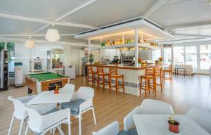a restaurant with a pool table and a bar at BJ Apartamentos Club Sa Coma in Sa Coma