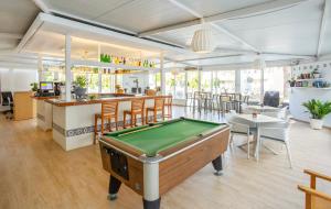a room with a pool table and a bar at BJ Apartamentos Club Sa Coma in Sa Coma