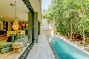 a house with a swimming pool in the middle of a yard at Luxurious Oasis Jacuzzi with Art Gallery and Pool in Tulum