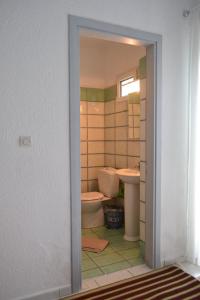 a bathroom with a toilet and a tub and a sink at Summer Family House with sea view and garden in Kriopigi