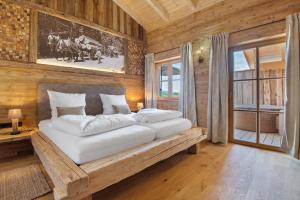 sypialnia z dużym białym łóżkiem w drewnianym pokoju w obiekcie Bergchalet 3 w mieście Freyung