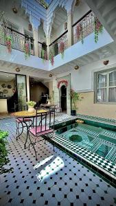 a house with a swimming pool in the middle at Riad Magnolia & SPA in Marrakech