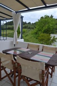 Summer House with sea view and garden في كريوبيجي: غرفة طعام مع طاولة وكراسي على شرفة