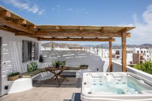 a hot tub on the roof of a house at Korali Hotel in Naxos Chora