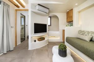 a living room with a tv and a couch at Korali Hotel in Naxos Chora