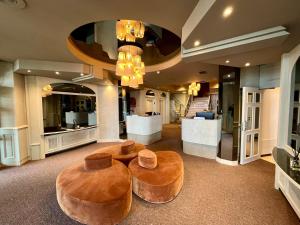 a lobby with two ottomans and two stools at Hotel Beach Palace in Blankenberge